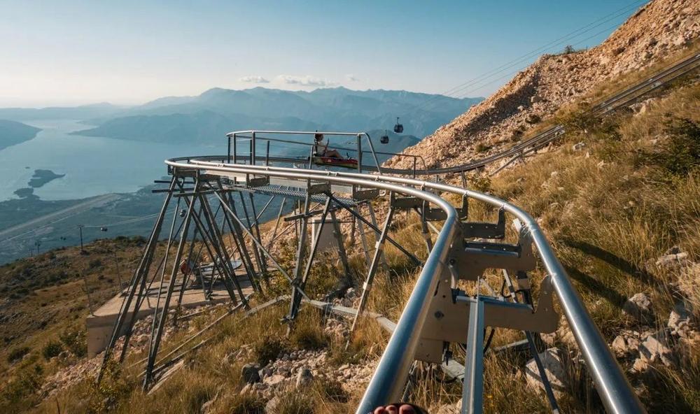 Alpine coaster cart on the mountainside above the bay