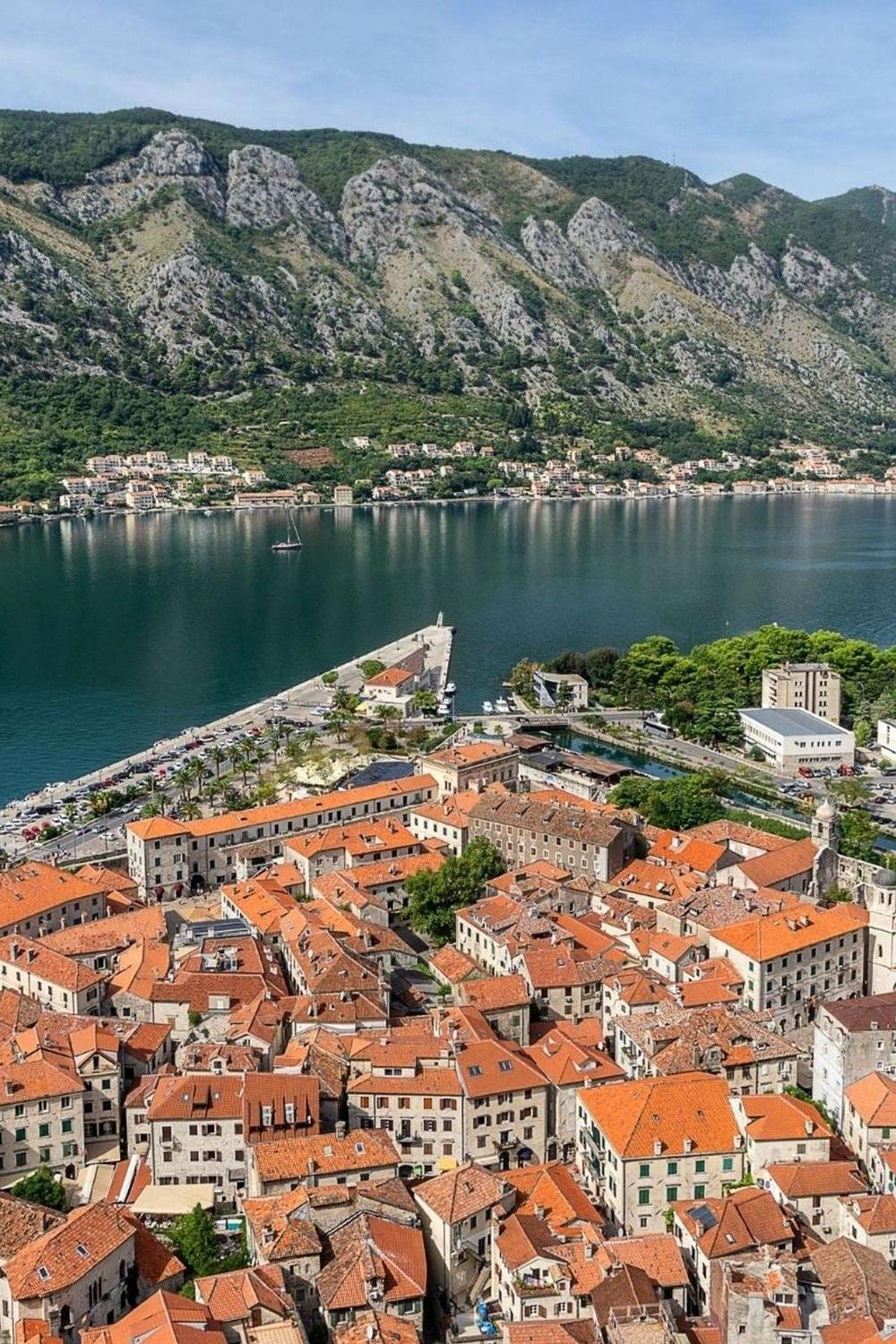 Kotor old town rooftops beneath the mountains
