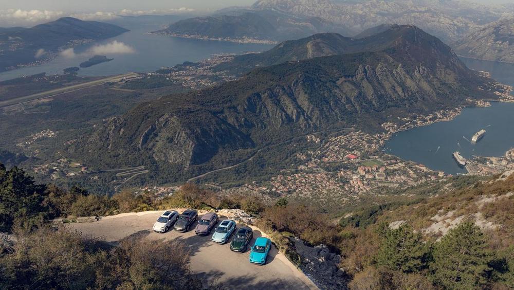 Cars parked at a viewpoint high above the Bay of Kotor